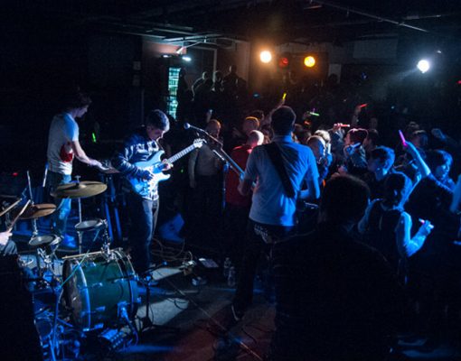 A musical band performs to a crowd in the Chamber Theatre