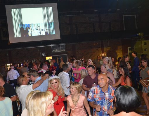 A party event at the Main Space in the Black-E. Crowds of partygoers dancing.